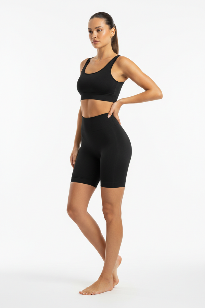 Model wearing The Define high waisted sculpting short in black, front view